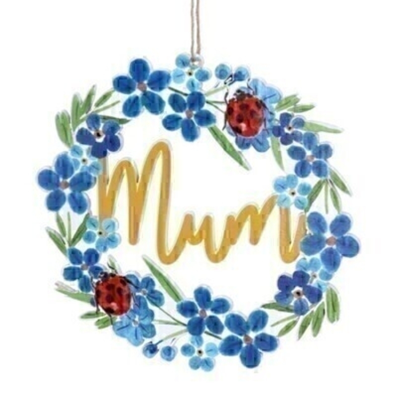 A blue wooden hanging decoration featuring forget-me-not flowers and ladybirds with MUM written inside the cut out. Made by London based designer Gisela Graham who designs really beautiful gifts for your home and garden.  Would suit any home decor and would make a lovely gift for your Mum. 